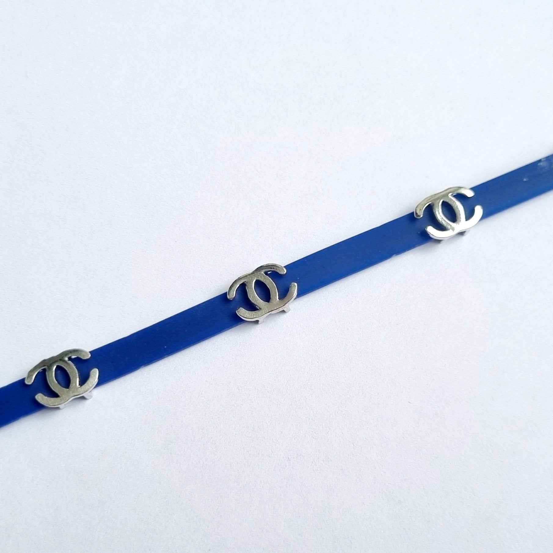 Sterling silver Chanel charm on blue bracelet for kids