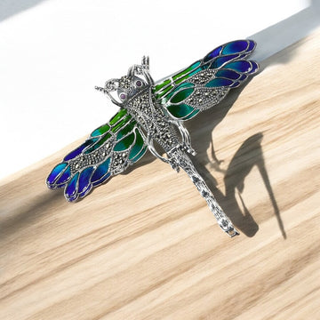 silver dragon fly brooch with oxidised finish and green and blue enamel