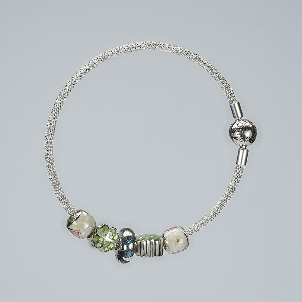 silver moving ball bracelet with white green enamel