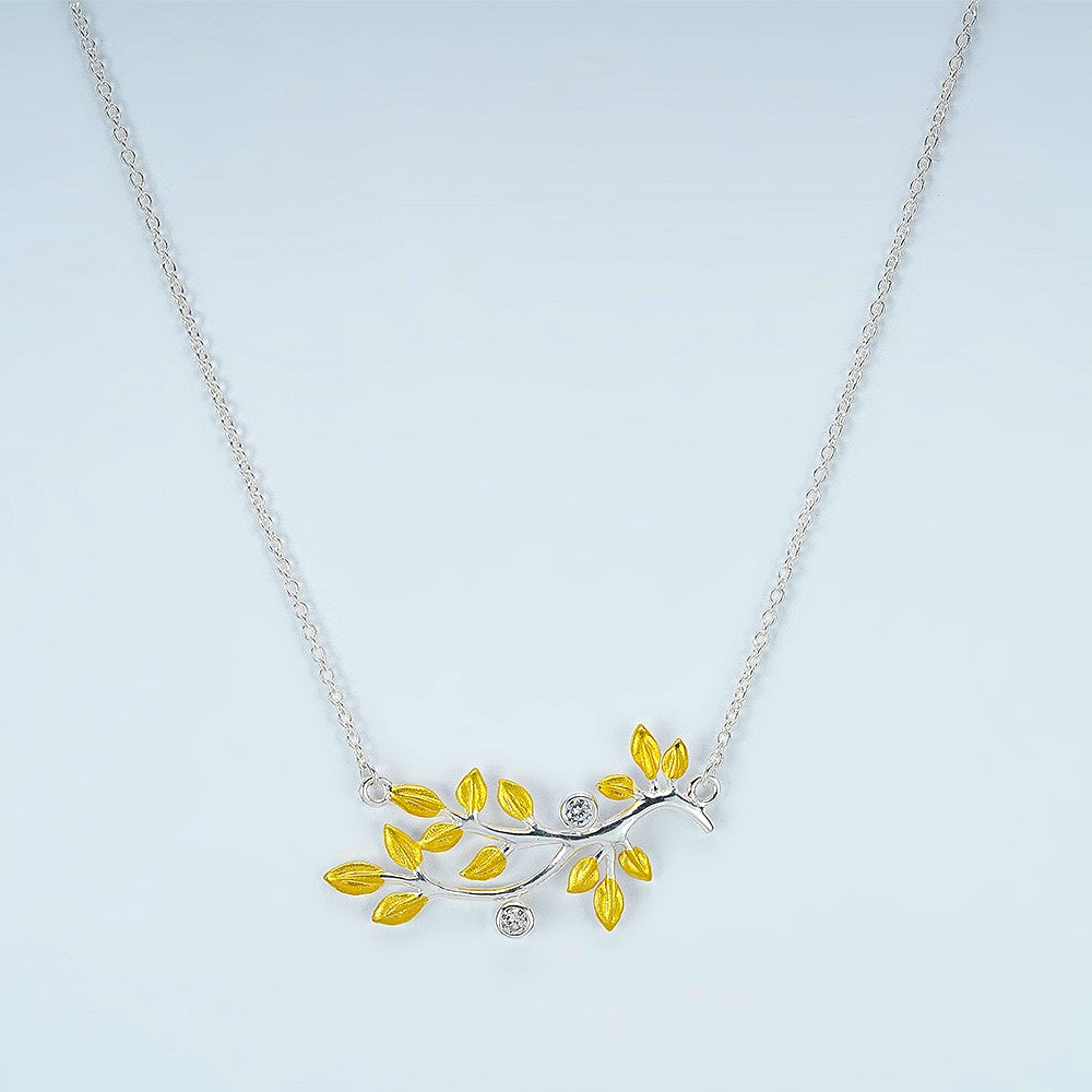 silver chain with gold plated branch out pendent studded with zircon