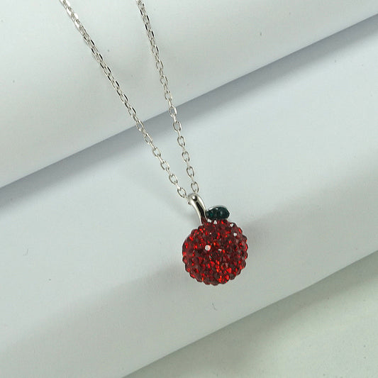silver necklace with apple pendant studded with red zircon